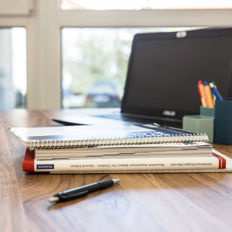 Laptop, Block und Stift auf Schreibtisch